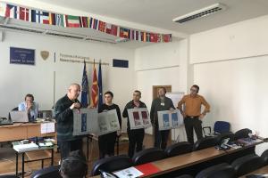 Participants explaining security printing techniques to their colleagues during a practical section of the training, Skopje, 5 November 2019. (OSCE/Angelisa Corbo)