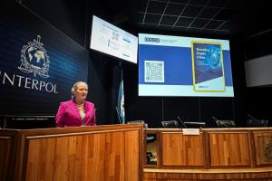 Vera Strobachova-Budway, Head of OCEEA’s Economic Governance Unit, presenting an OSCE guide on n virtual assets for law enforcement at the INTERPOL Virtual Assets Summit in Lyon, France, 28 March 2025. (OSCE)