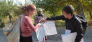 Walking alongside cotton fields in villages outside Vose, Voter educator Emomjafar Ashurov (r) stopped harvesters along the way, and described procedures for casting ballots. (Jamshedi Davlat)