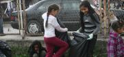 Children help clean up the yard of the clinic in Shuto Orizari municipality. (OSCE/Mirvete Islam)