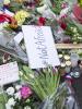 A man places a candle at the scene of a shooting at cafe 'Krudttonden,' which was hosting a free speech event, in Oesterbro, Copenhagen, February 16, 2015. (Reuters)