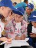 Ukrainian children solving a quiz on discovering an unexploded military ordonance during the Young Firefighters festival in Zaozerne, Crimea on 9 September 2013. (OSCE/Viacheslav Voloshyn)
