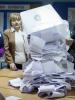 A member of a local electoral commission empties a ballot box after a parliamentary election at a polling station in Chisinau, 30 November 2014. (Reuters)