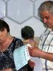Voters study their ballot papers for the 3 June 2007 local elections in Moldova. (OSCE/Curtis Budden)