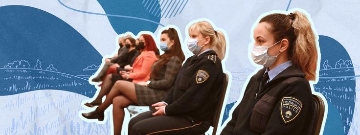 Uniformed officers in black hats standing in formation, focused and attentive.